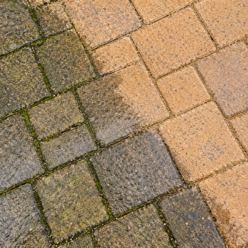 Rotary cleaner edge on block paving, clean strip beside dirty